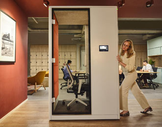 Video conferencing office pod being used for a team meeting