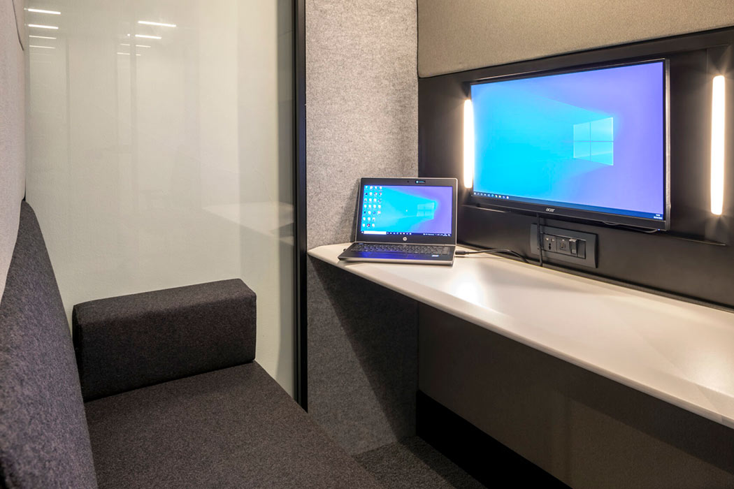 Inside the Calma Z2 pod with sofa and monitor for video conferencing.
