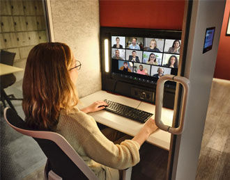 Video conferencing office pod being used for a team meeting