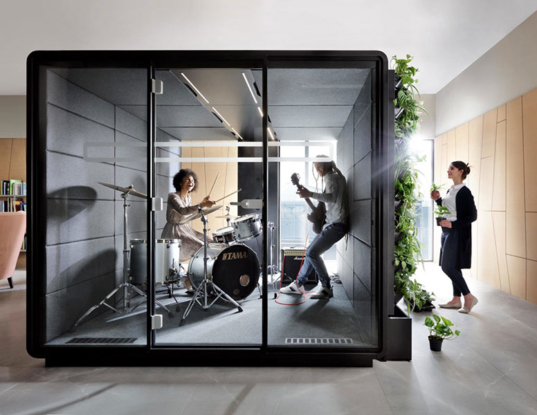 Large office pod with band playing music inside