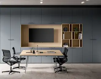 Storage wall in meeting room with built-in display.
