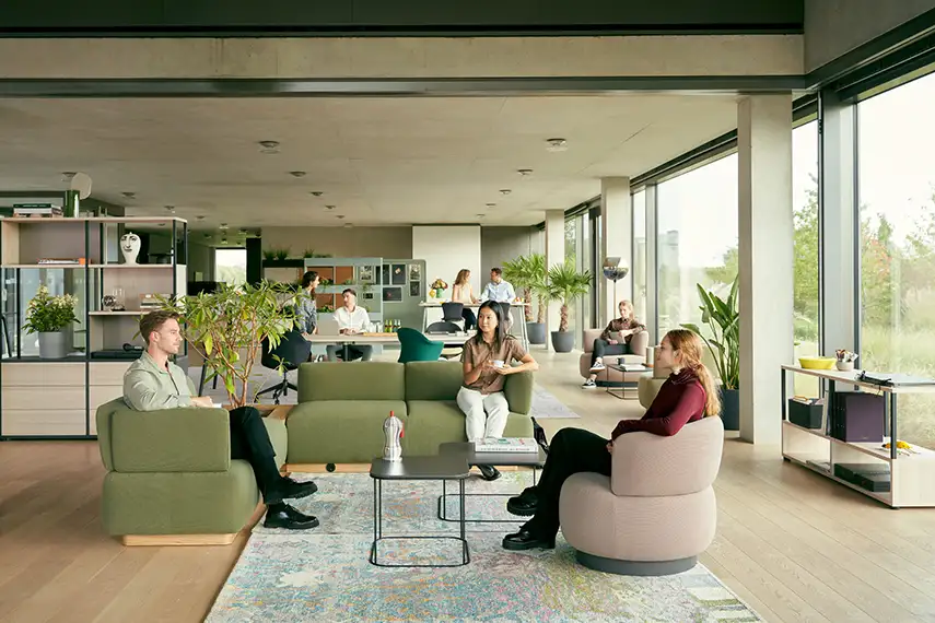 Breakout space with sofa and lounge chair in office 